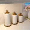 White Ceramic Jar With Gold Flower Lid (3 Sizes) 2 White Ceramic Jar With Gold Flower Lid (3 Sizes) -Home Essentials Shop IMG 2783 new